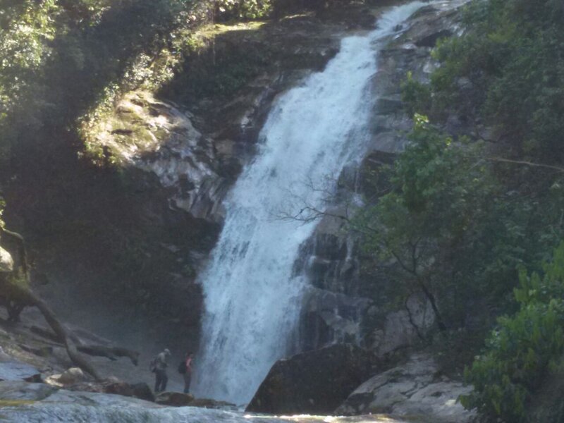 Two People Near Waterfall — Green