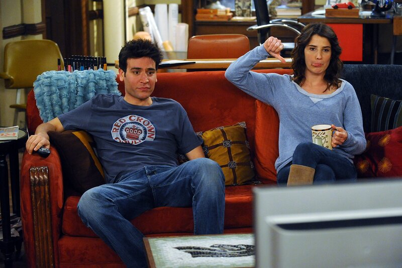 Two people on a couch watching TV