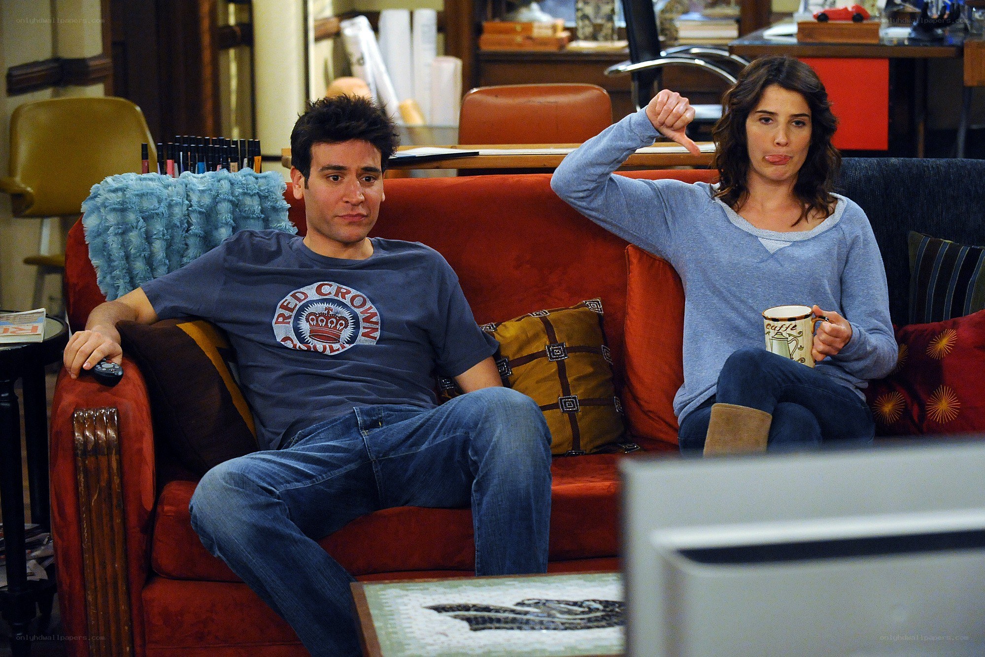 Two people on a couch watching TV