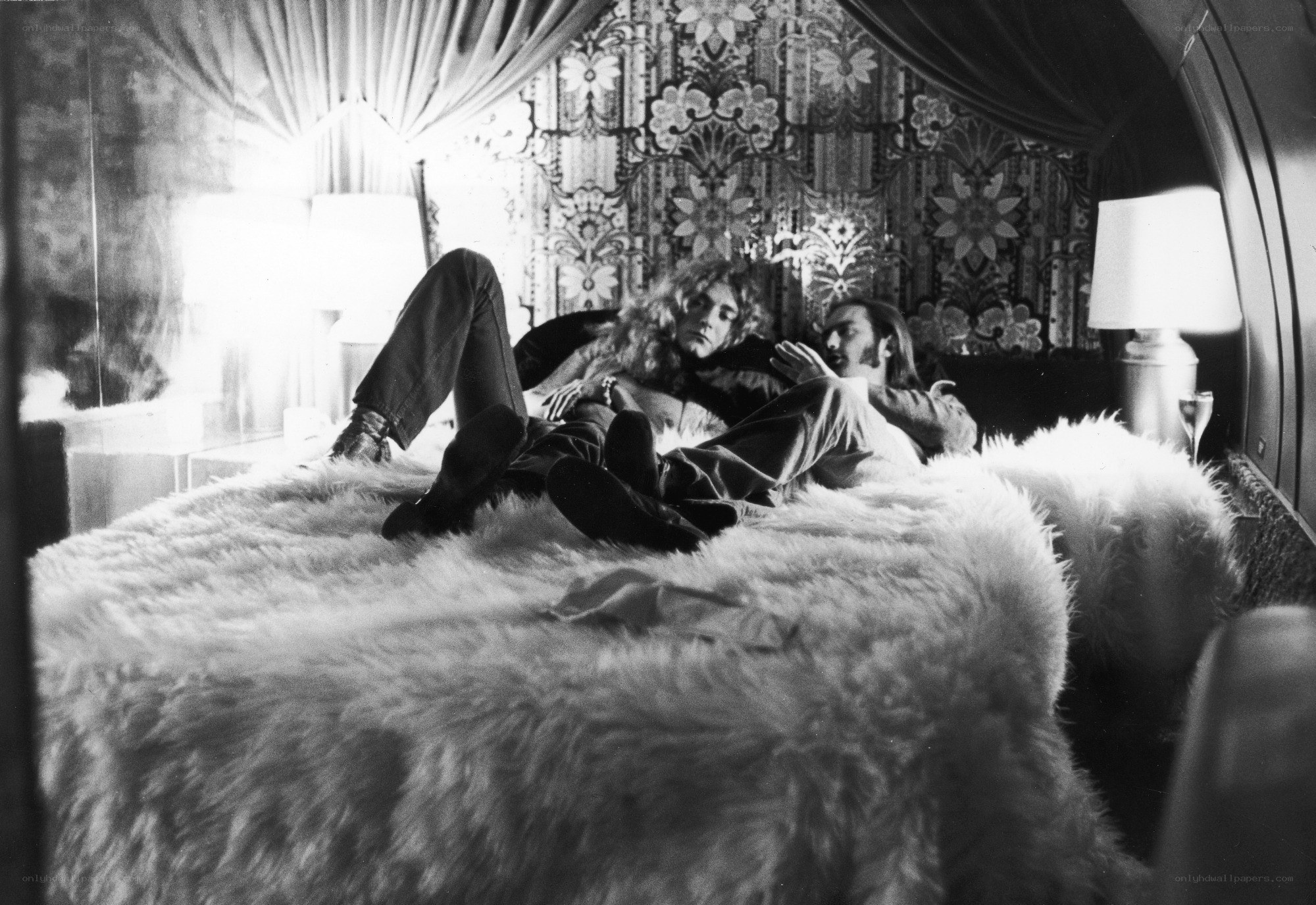 Two people on a fur-covered bed
