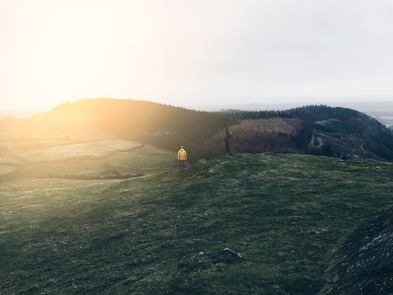 Two People on a Hill — Green, Serene, Sunset