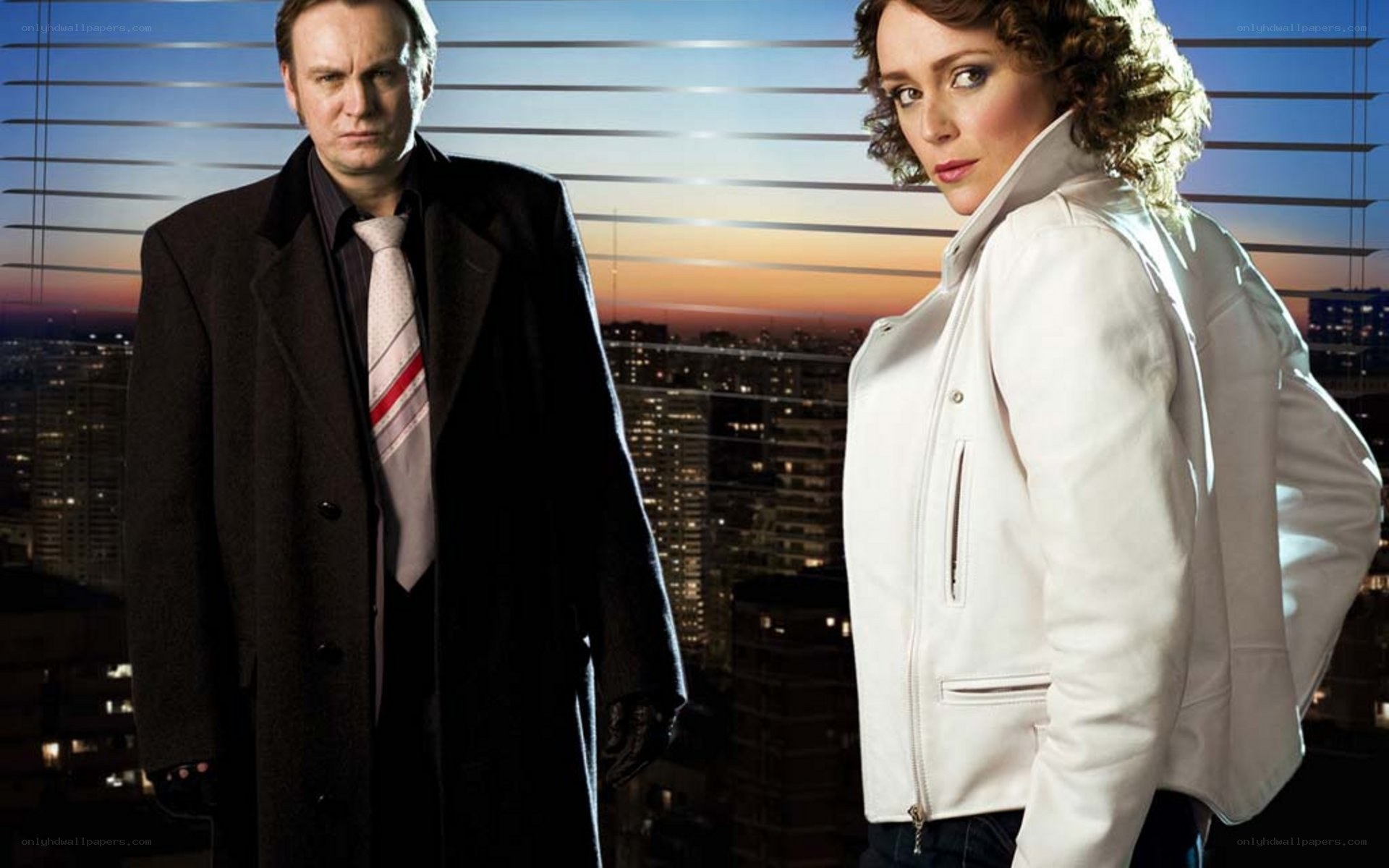 two people on a rooftop at dusk