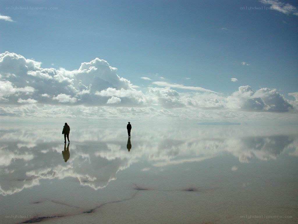 Two people on a salt flat