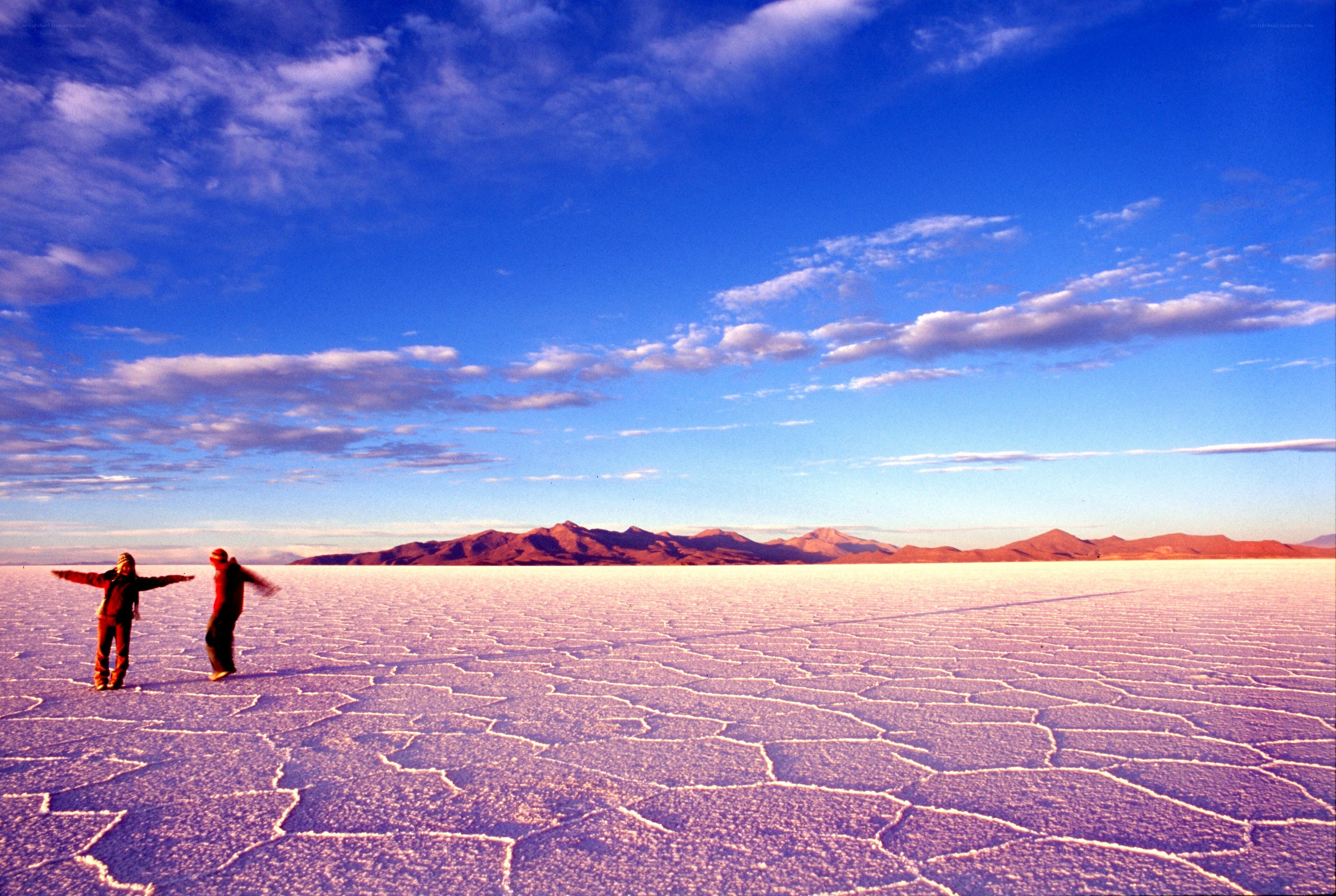 Two people on a salt flat