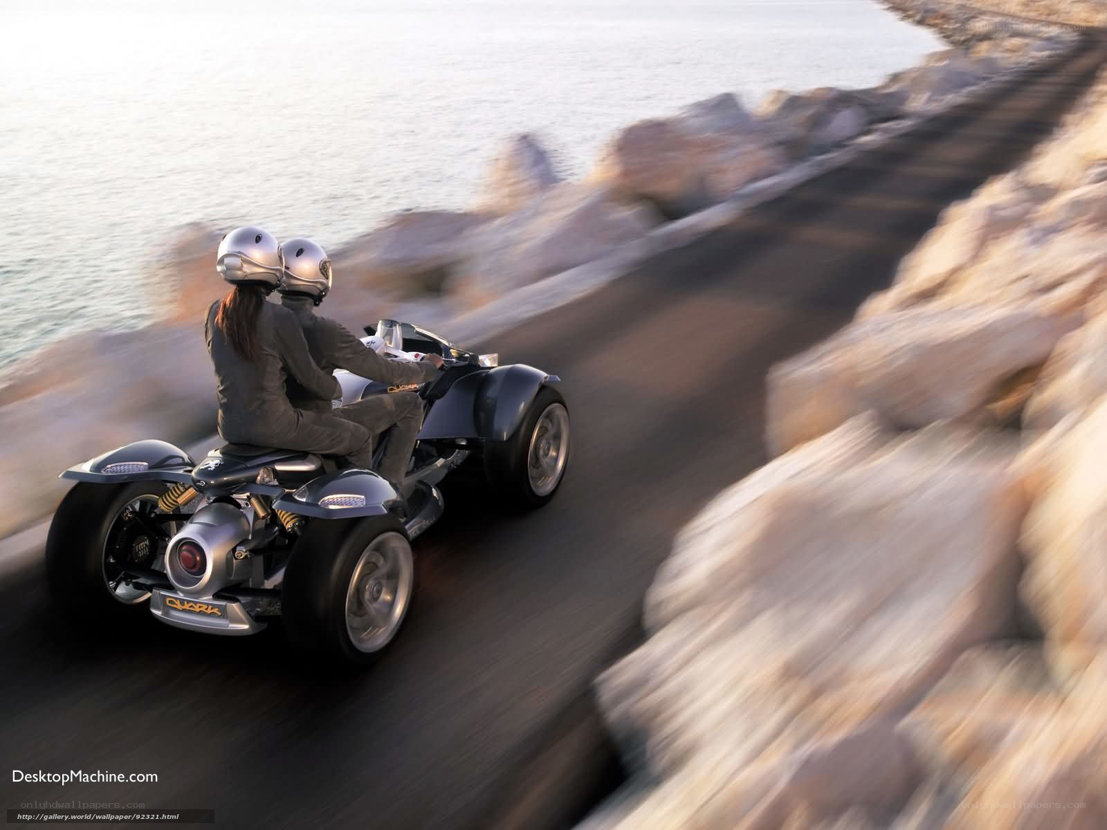 Two people on a three-wheeled vehicle