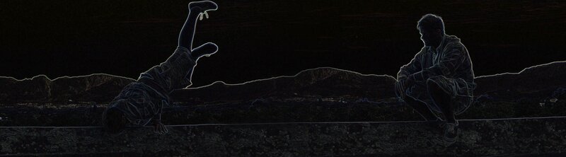 Two people on a wall at night
