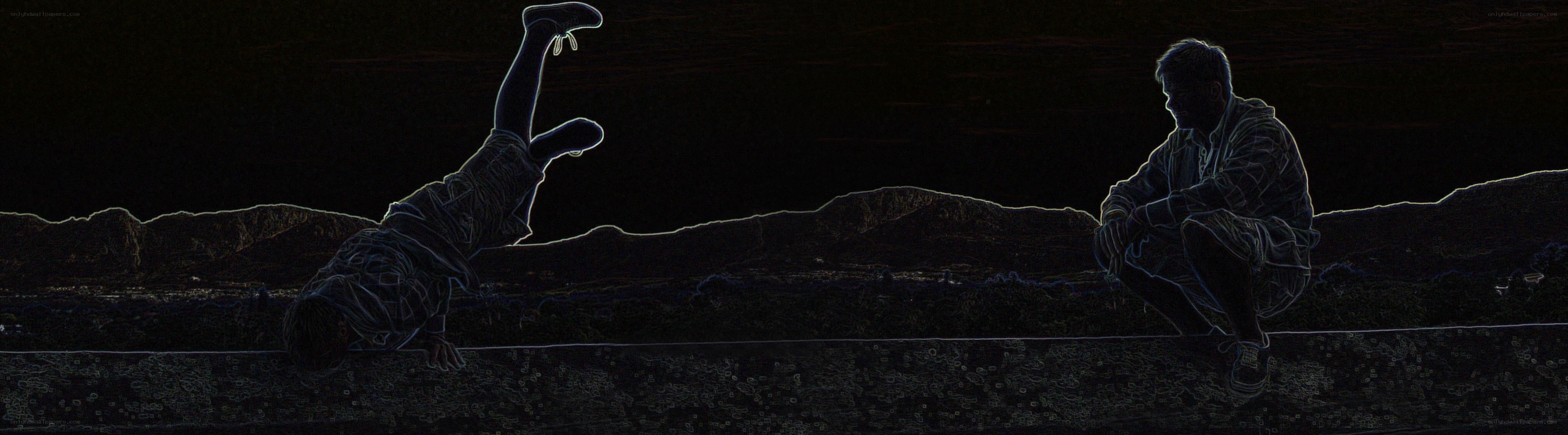 Two people on a wall at night