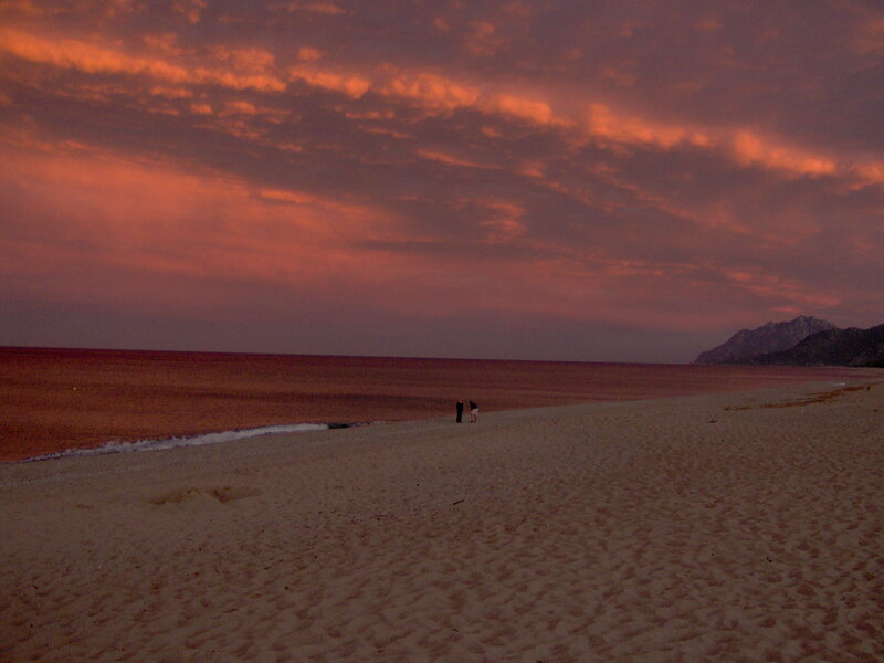 Two People on Beach — Orange, Dramatic, Sunset, Photograph, Ocean, Mountains