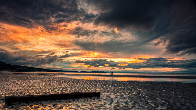Two People on Beach — Orange, Dramatic, Sunset
