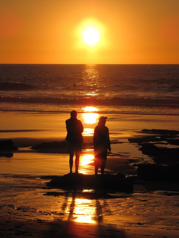 Two People on Beach — Orange, Serene, Sunset, Photograph, Sun, Ocean, Sand, Yellow