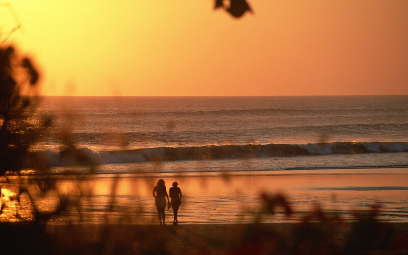 Two People on Beach — Orange, Serene, Sunset, Photograph