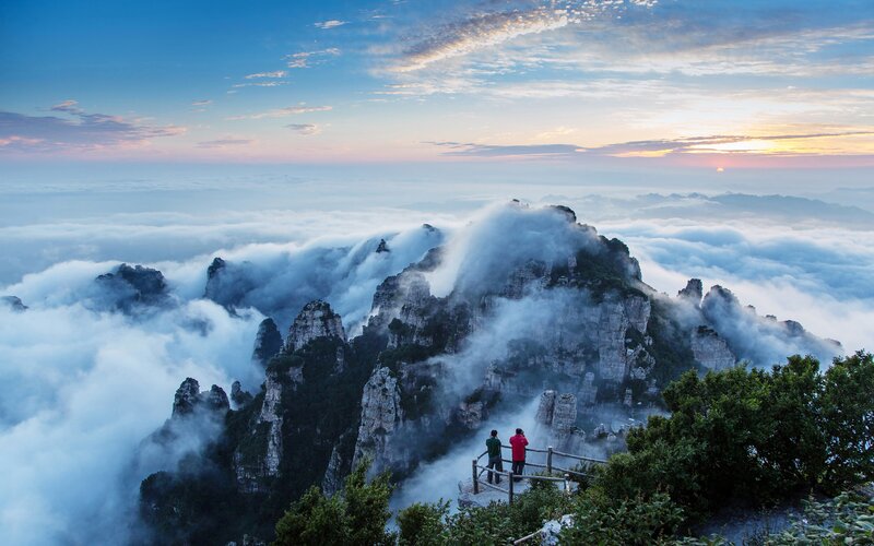 Two People on Mountain Peak — Blue