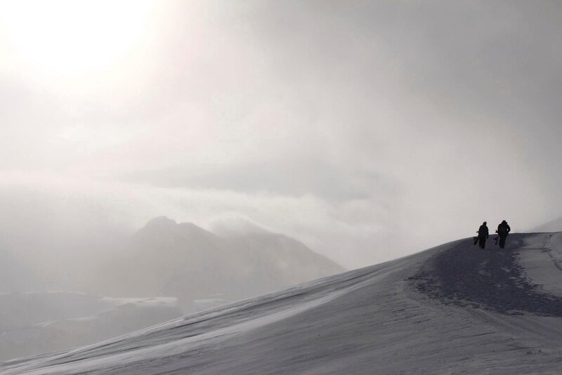 Two People on Snowy Slope — White
