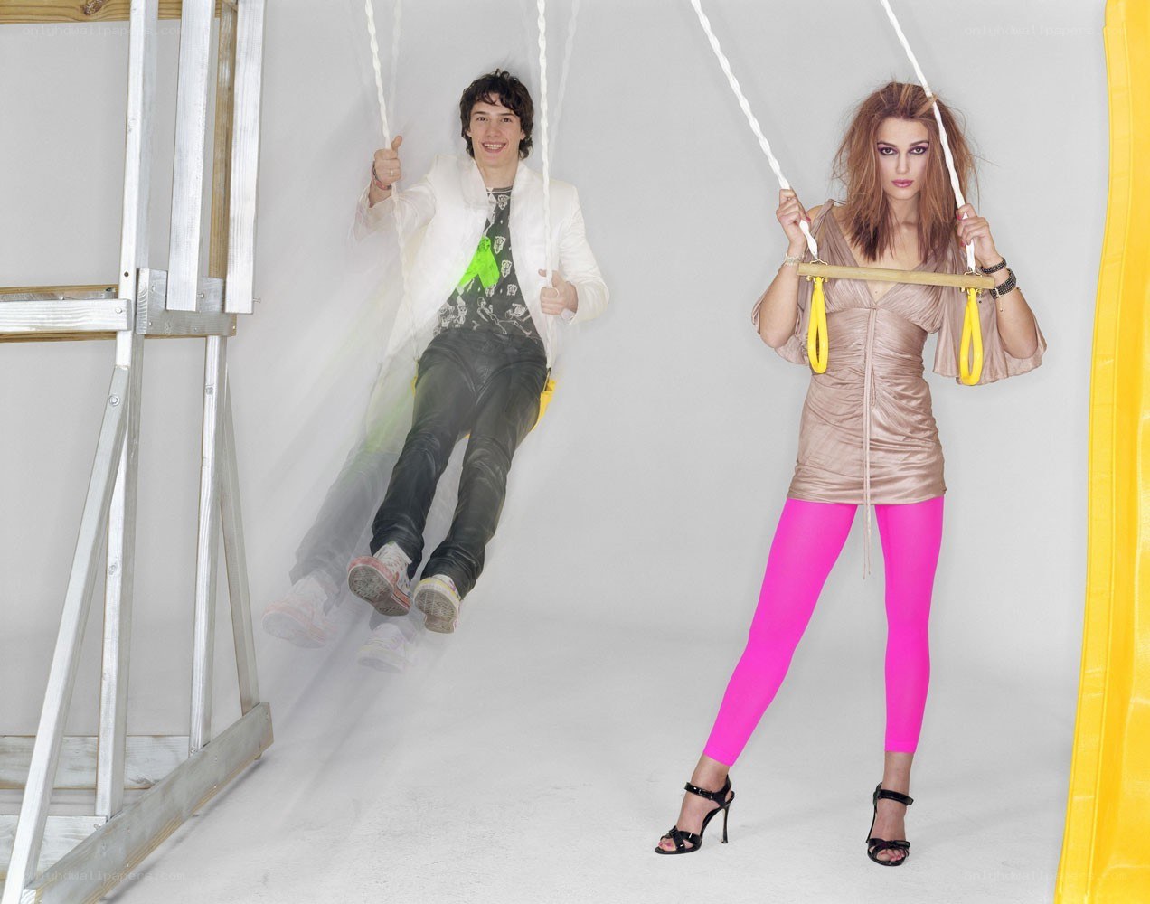 Two people on swings in studio