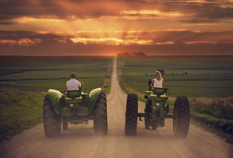 Two People on Tractors — Green
