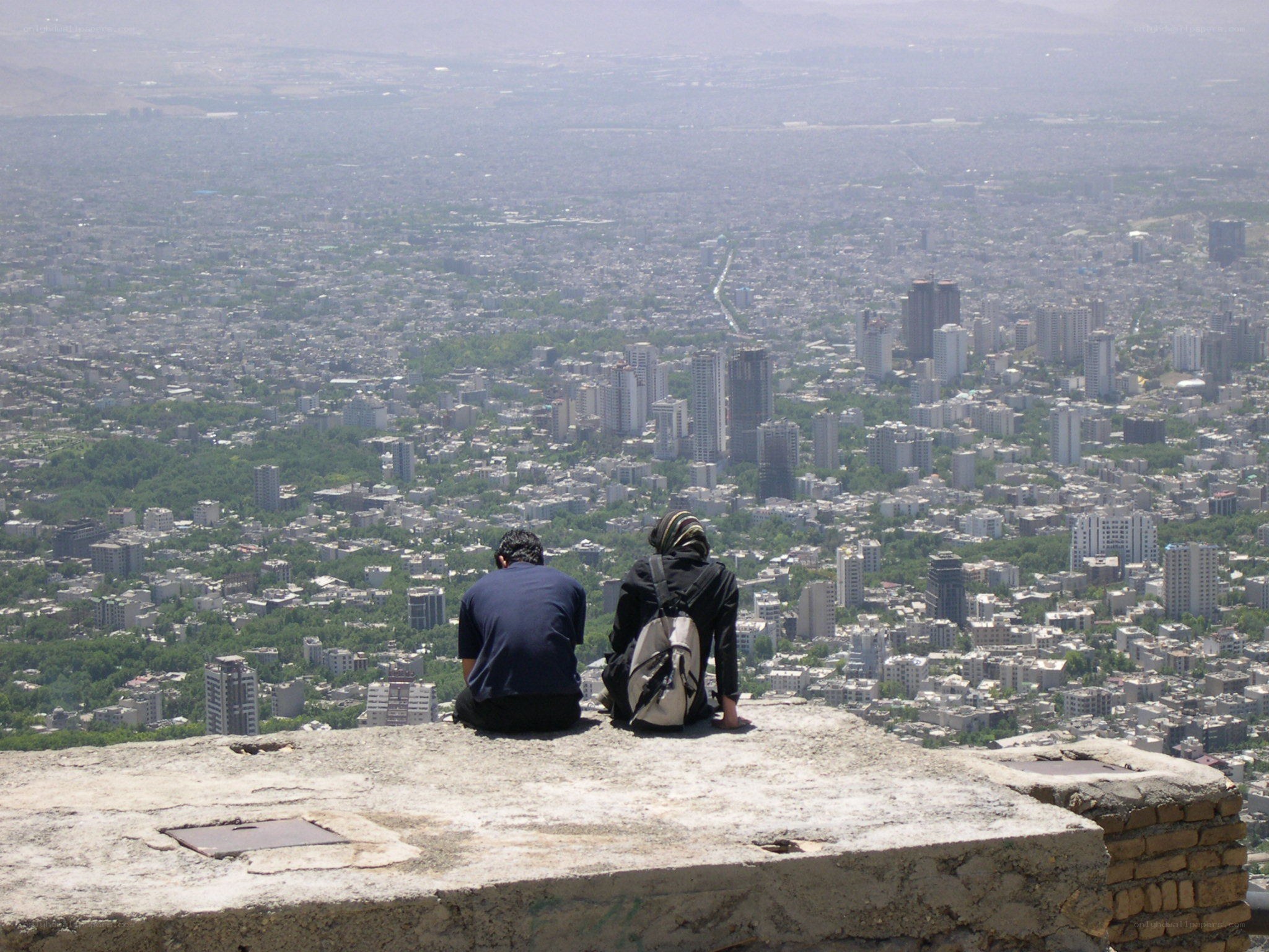 Two people overlooking a city