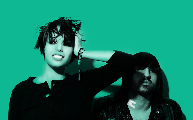 two people posing against green background