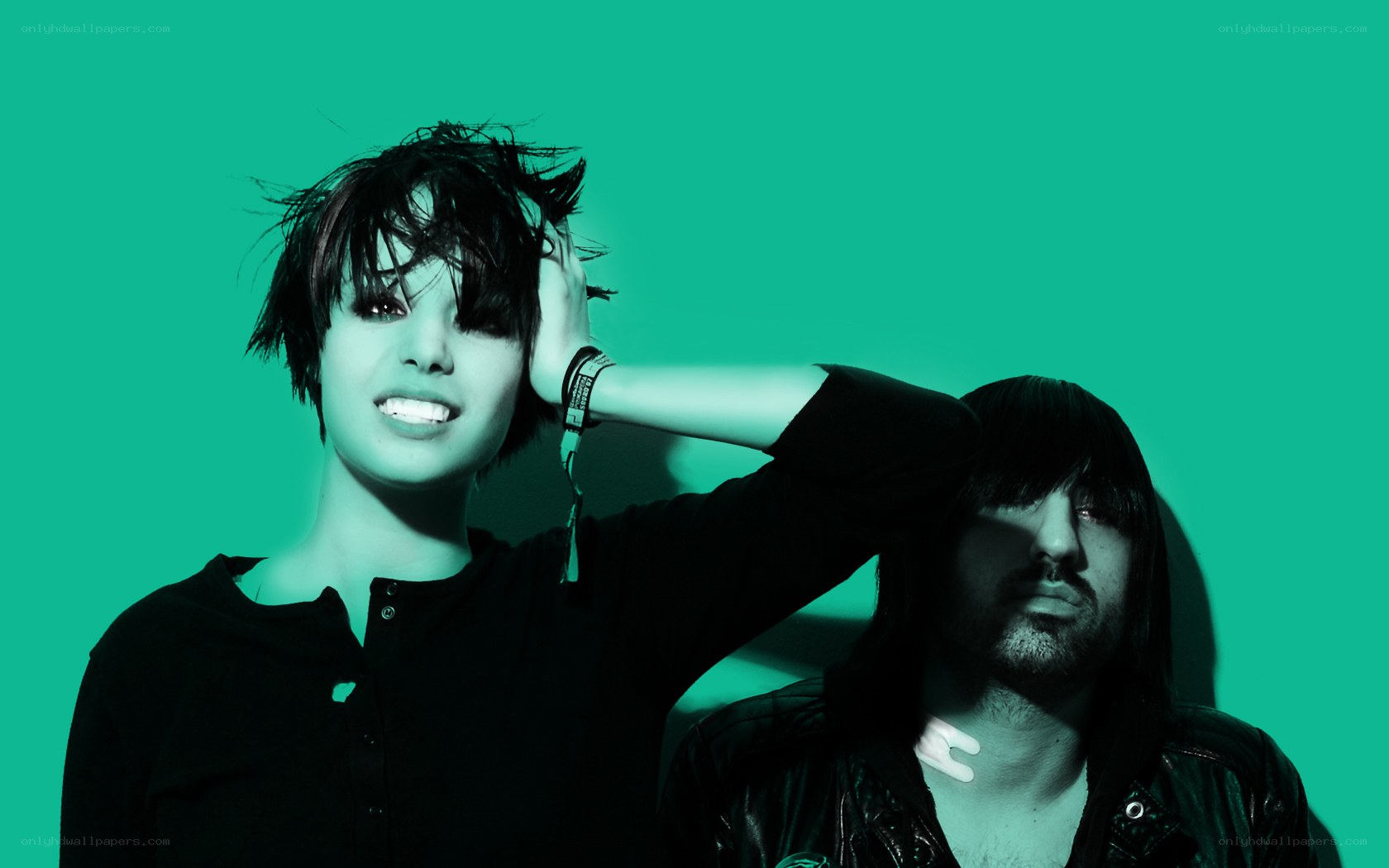 two people posing against green background