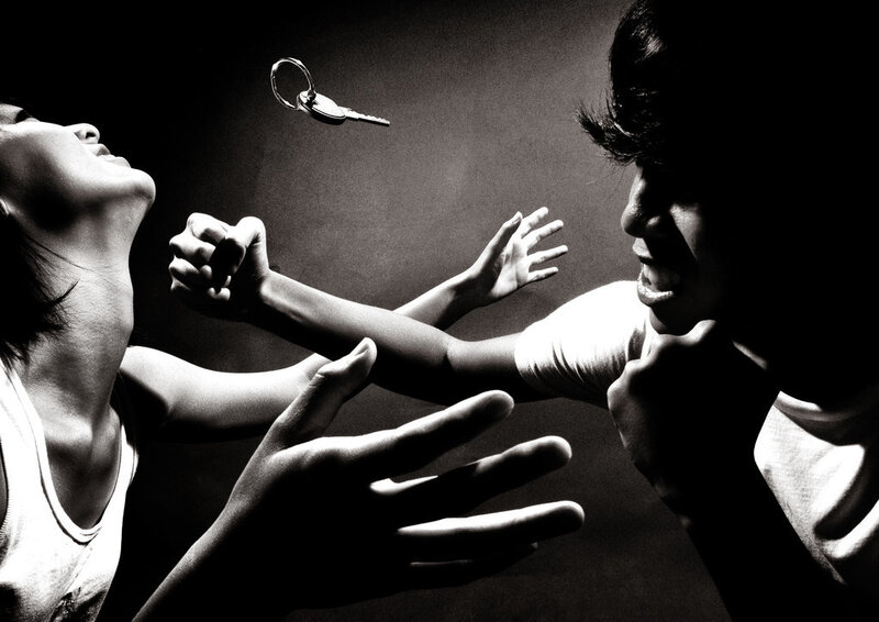 Two people reaching for a key