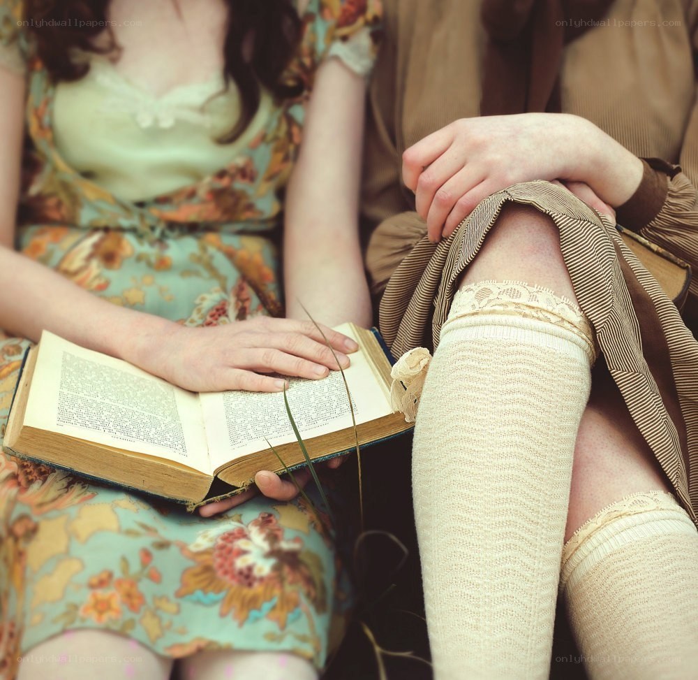 Two people reading a book together