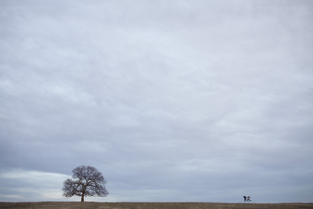 Two people running on a hill