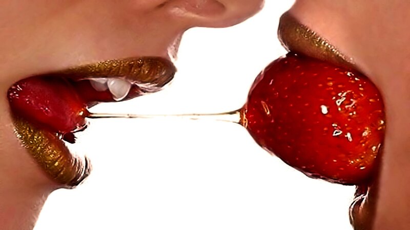 two people sharing a strawberry