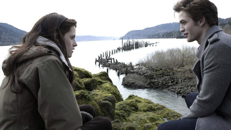 Two People Sitting by Water