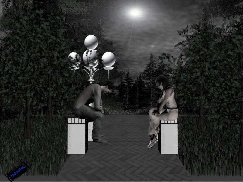 Two people sitting in a park at night
