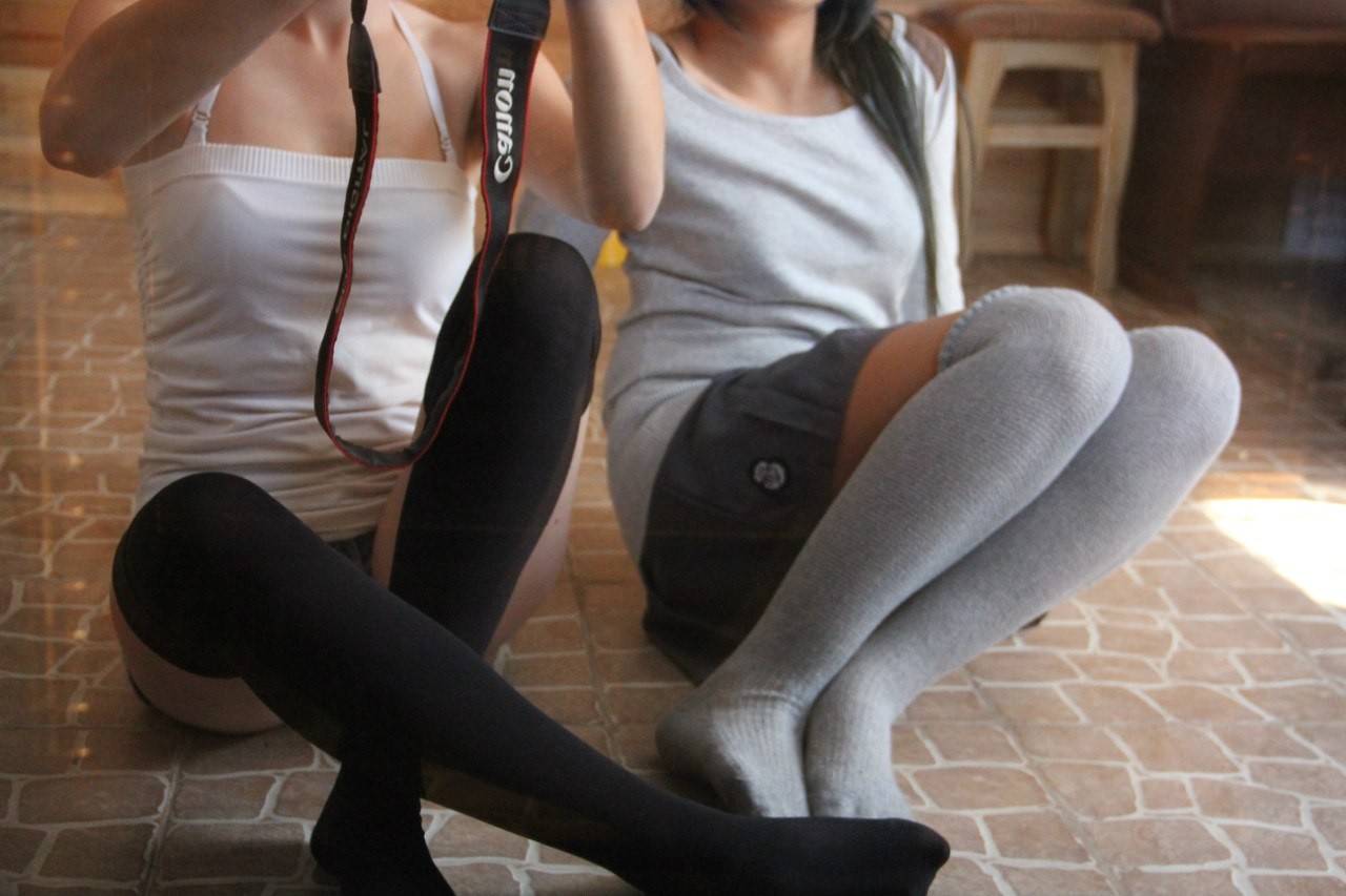 Two people sitting on floor