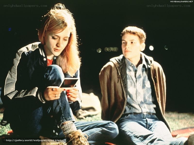 two people sitting on grass