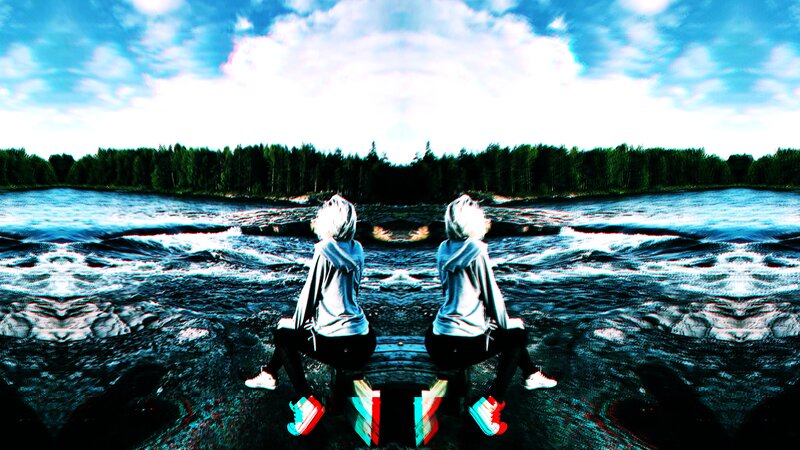 Two People Sitting on Riverbank
