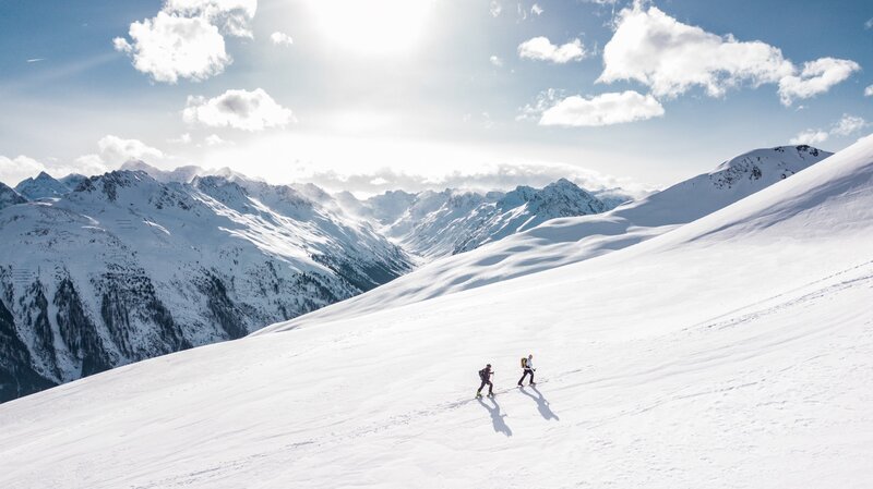 Two People Skiing — White