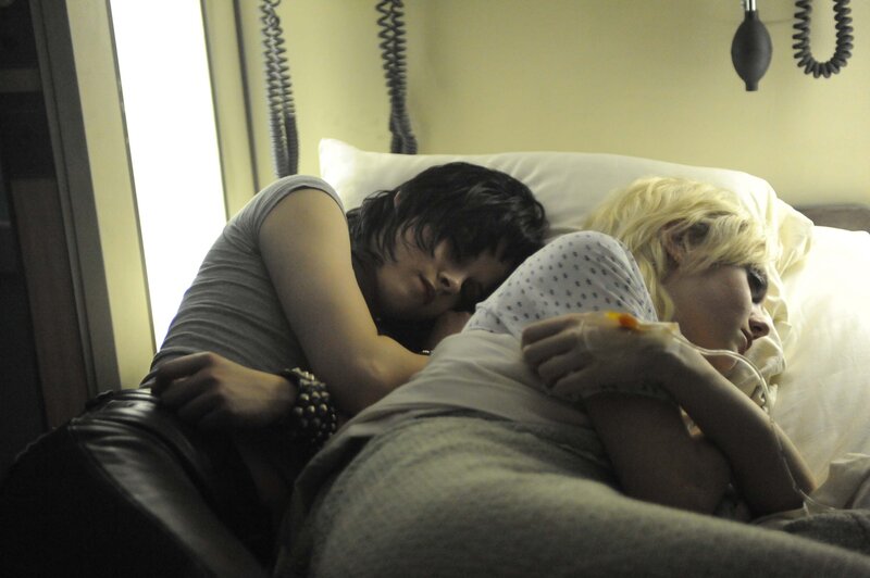 Two people sleeping in a hospital bed