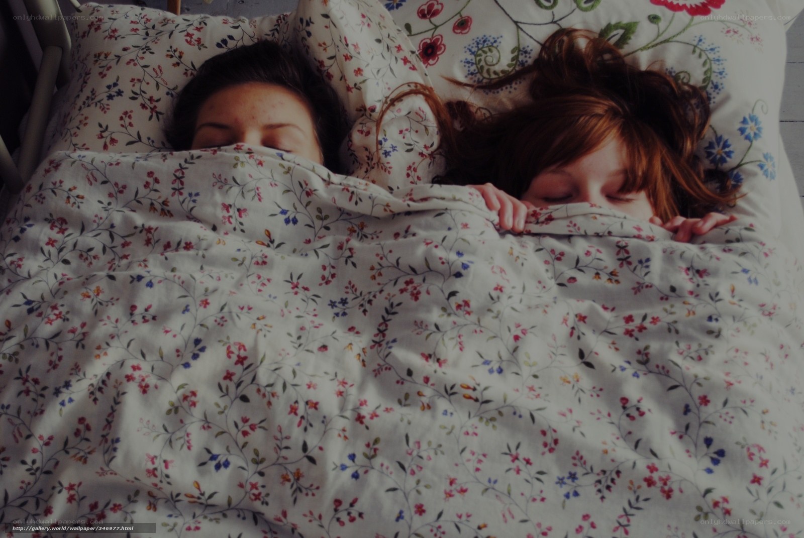 two people sleeping in bed