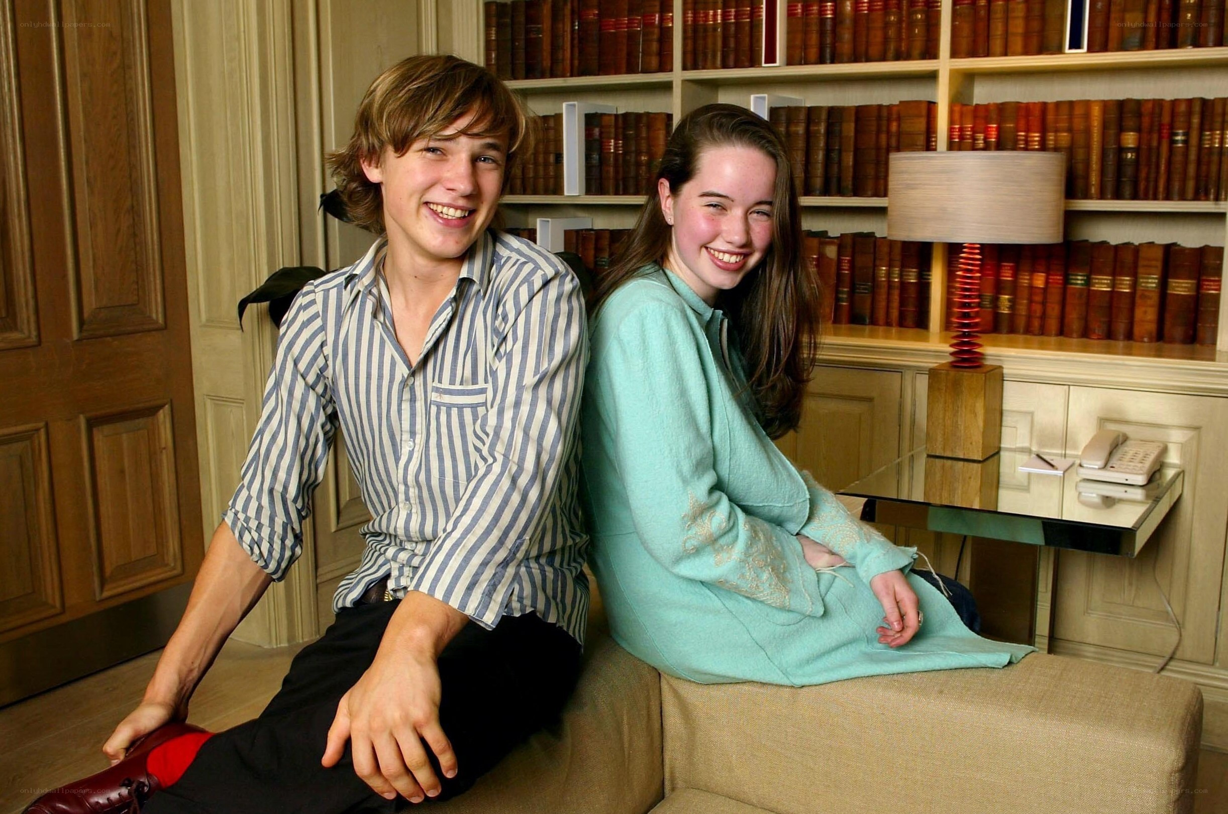 Two people smiling in a library