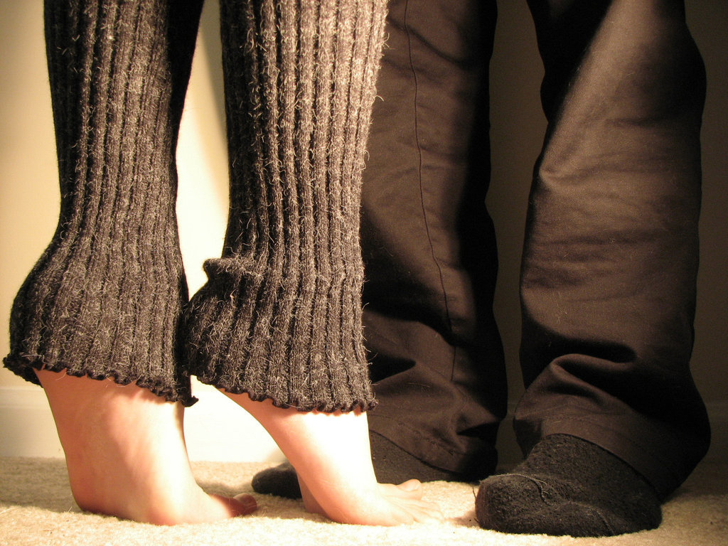 two people standing barefoot