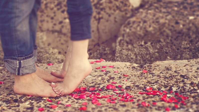 Two People Standing Barefoot — Red