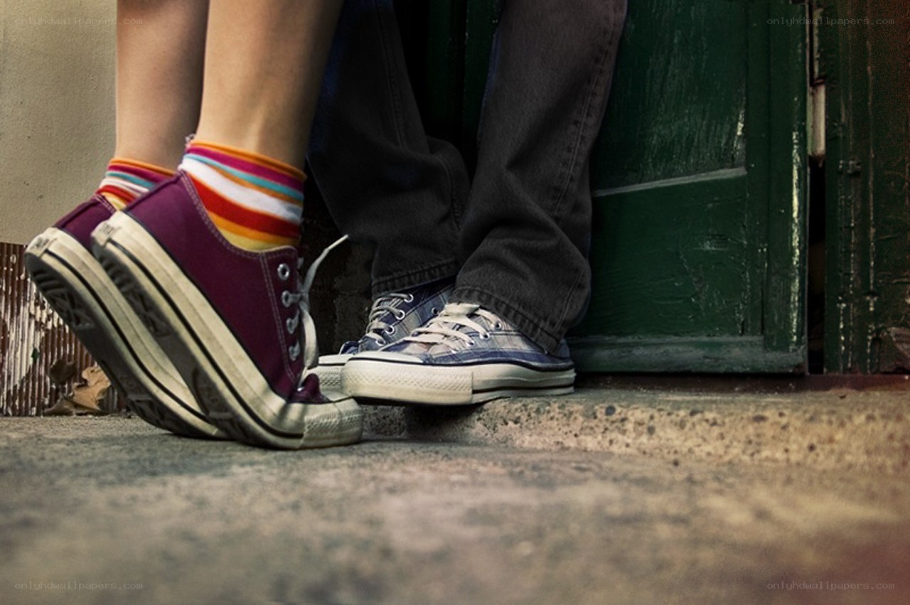 two people standing by a door