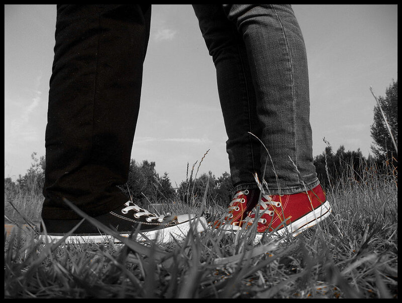 two people standing in grass