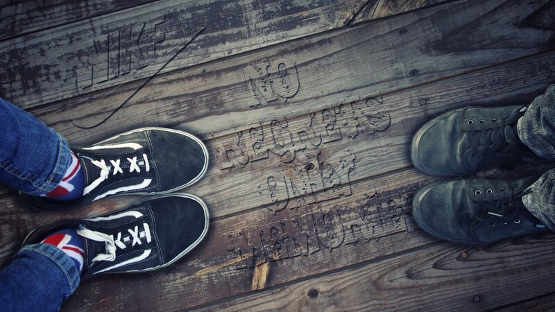 two people standing on wooden floor