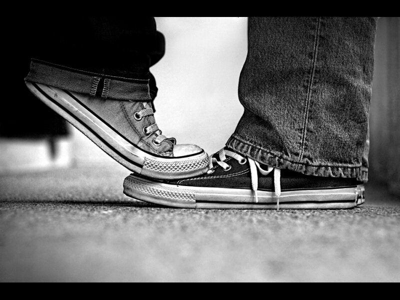 two people touching shoes