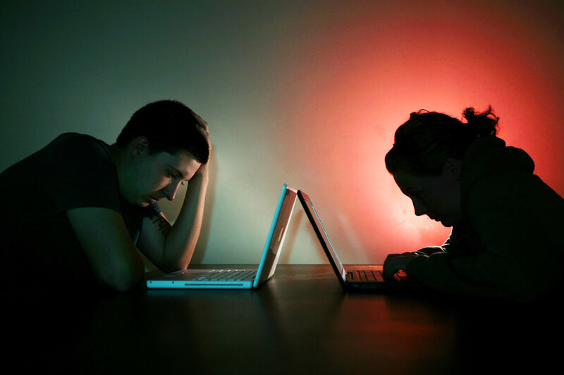 Two People Using Laptops