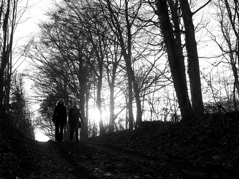 Two People Walking in Forest