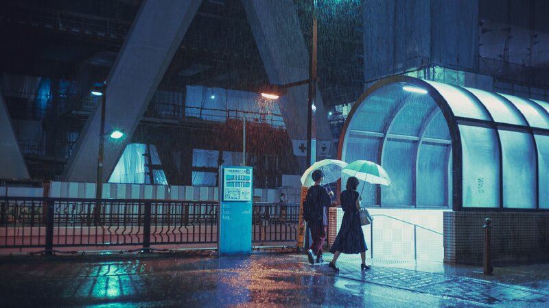 Two People Walking in Rain