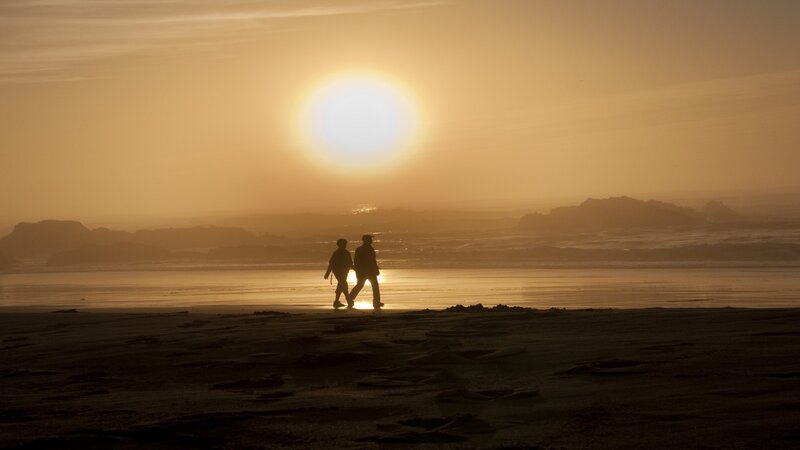 Two People Walking on Beach — Orange, Serene
