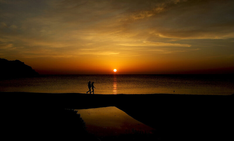 Two People Walking on Beach — Orange