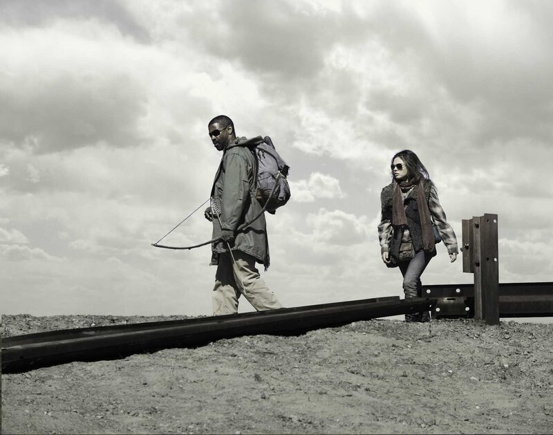 two people walking on train tracks