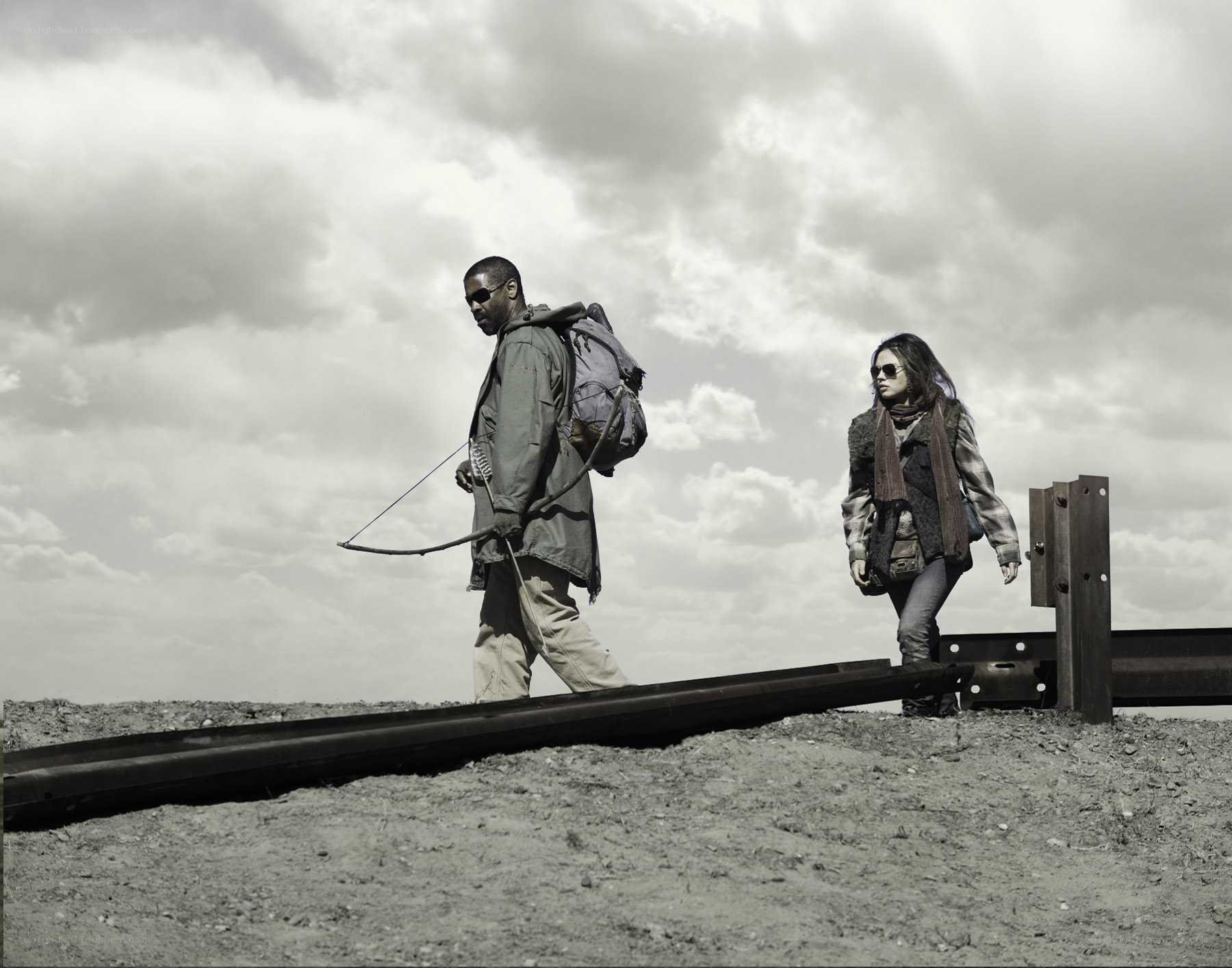 two people walking on train tracks