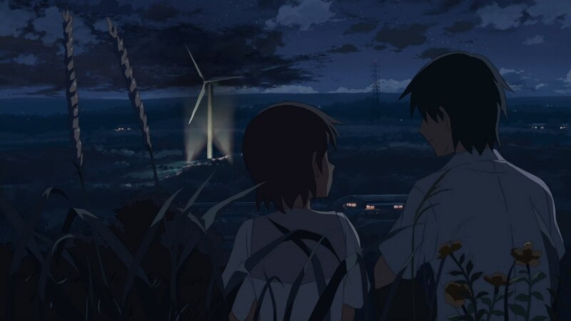 two people watching wind turbine