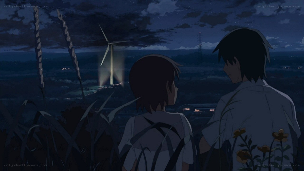 two people watching wind turbine